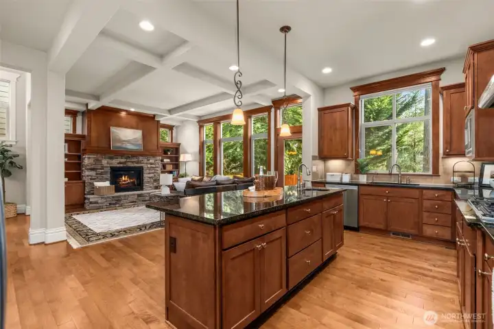 Stunning millwork & box beamed ceilings in the grand-scaled living room.