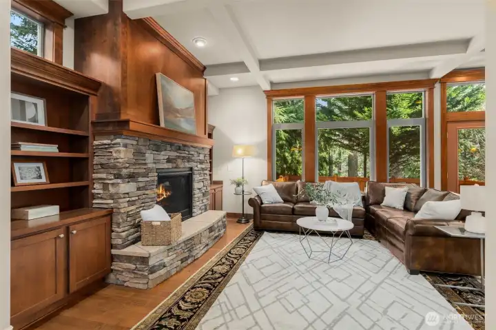 Natural light from expansive windows that frame serene views of a protected greenbelt.