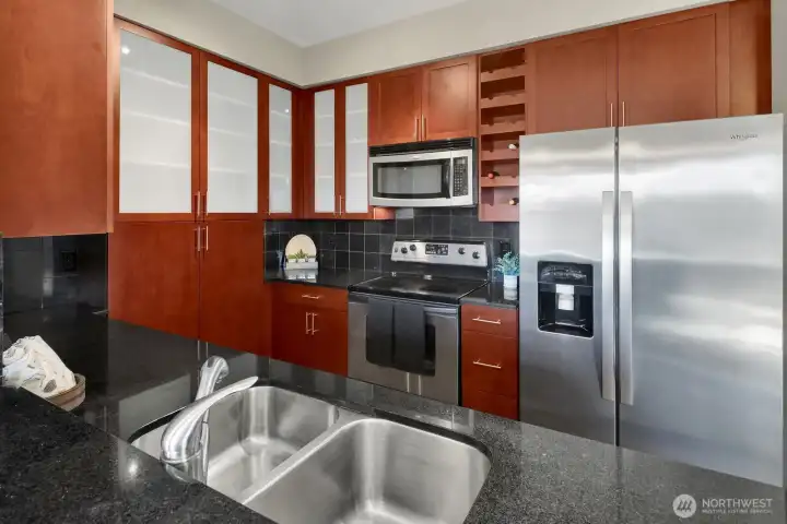 Stainless appliances grace the sassy kitchen.