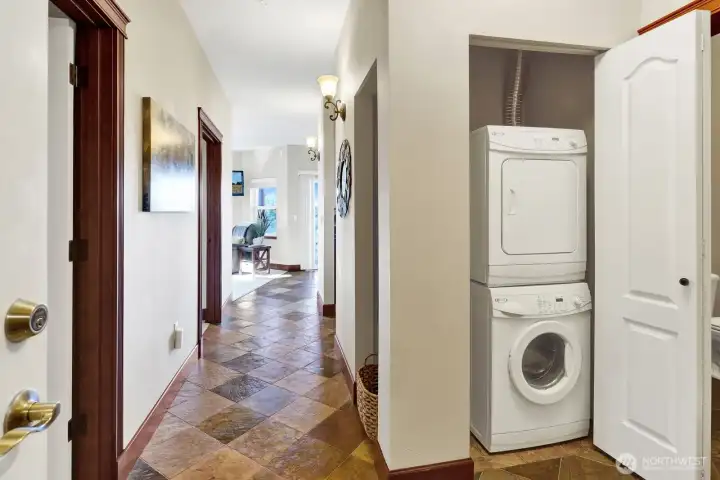 The closet accommodates the stacked washer/dryer just outside the bathroom door.