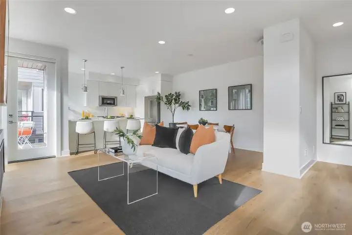 Living area with hardwood floors and recessed lighting.