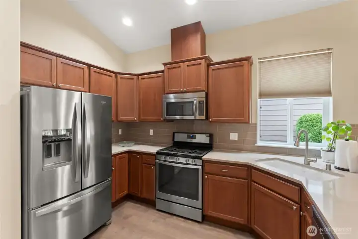 Custom quartz countertops, large undermount sink and newer refrigerator is ready for the next chef.