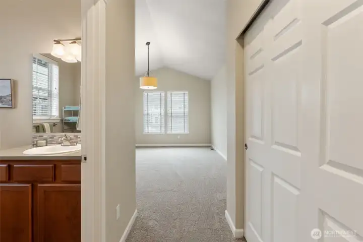 View into the second bedroom showing the bathroom entry on the left.