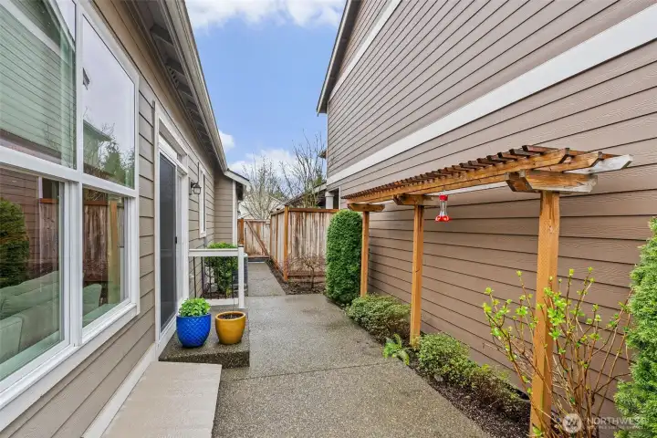 Towards the gate is an area for garbage can storage.