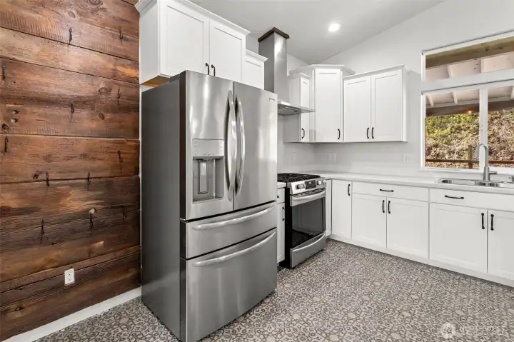 Vaulted ceilings, lots of natural light, featuring an abundance of cabinetry, and stainless appliances.