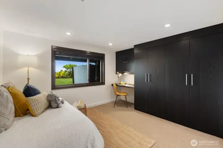 3rd bedroom with desk and built-in cabinets