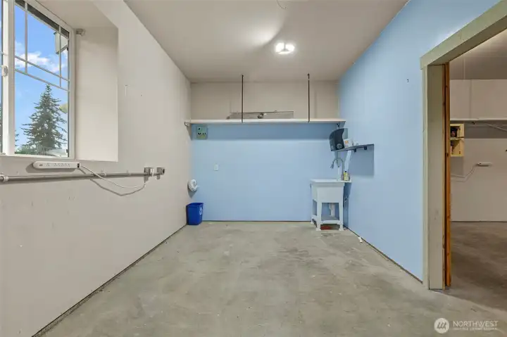 The third bay in the garage has been converted into an artist's space complete with sink and 220 power.  It can still easily function as a garage bay.