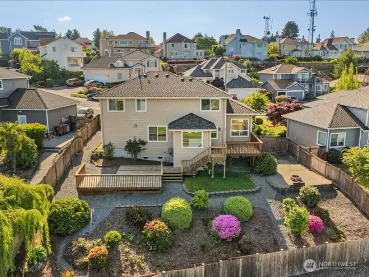 Fully fenced backyard!   Entertainers delight with all of the decking.  Firepit and very mature low maintenance landscaping.