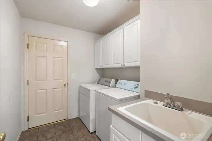 Main floor laundry room with door out to the garage.
