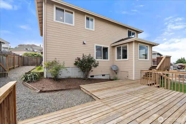 The backyard is very spacious, has great landscaping and that wonderful multi-layered deck.