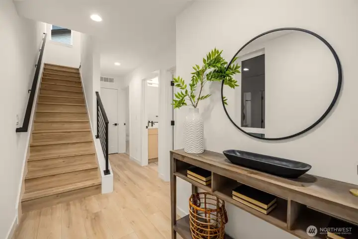 Bright foyer featuring a stylish wood accent wall and convenient built-in entry console area. (photos are of model home, similar finishes & quality)