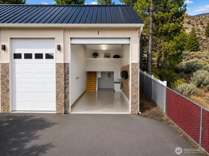 Spacious garage with soaring ceilings, built-in storage, and oversized loft - perfect for boats, RV's, and all your recreational gear.