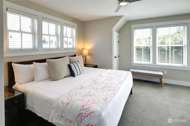 ...you will find the tree house like primary bedroom.  Surrounded by windows and territorial views, this retreat is private and quiet.
