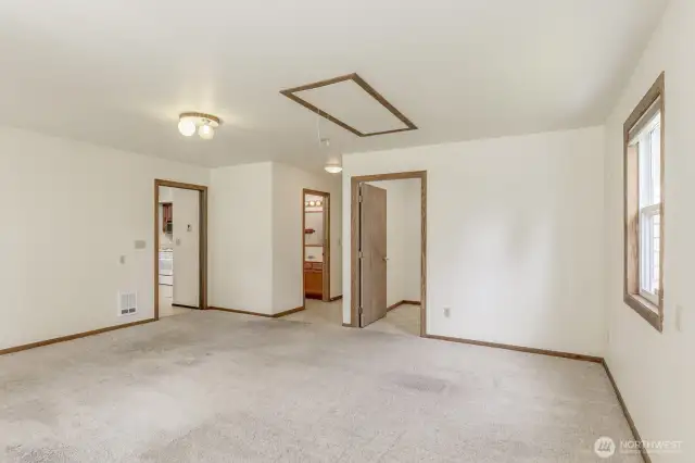 Looking the other direction in the bonus room. Past the half bath is the door to the garage and the walk in pantry is on the right.