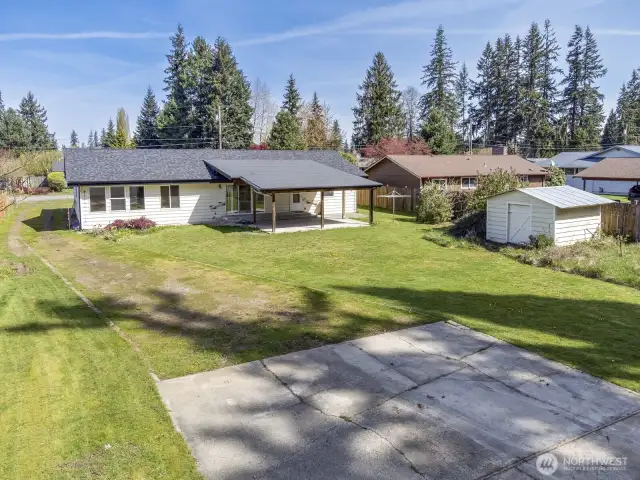 The rear yard faces south for all day sun. The huge covered patio is perfect for summer BBQ's. The tool shed is great lawn mower storage.