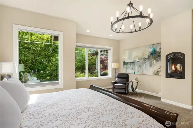 Simple luxuries like the gas fireplace, reading nook and extra large windows overlooking gardens complete the large Primary Bedroom