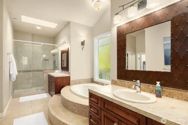 The over sized frameless shower, skylight and his and hers vanities complete the spa bathroom