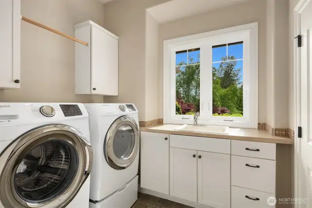 The large and sunny laundry room on main with oversized utility closet