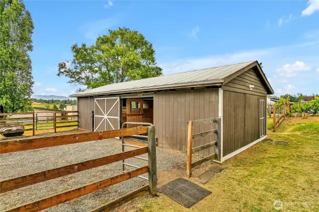 Three stall barn with tack room connects to goat pen