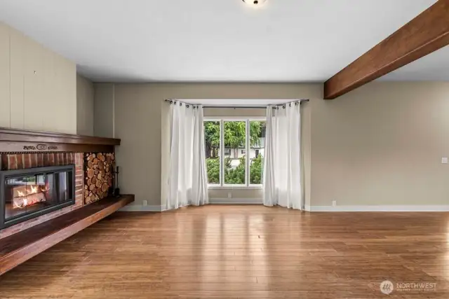 Spacious living room with built in wood fire place.