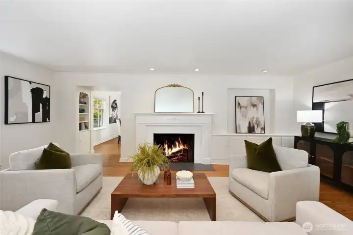 Looking towards the dining room- notice the built in cabinets next to the fireplace and shelves lining the hall to the dining room