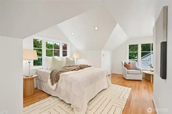 Upstairs this is the larger of the two bedrooms. Love the peaked ceilings and big windows!