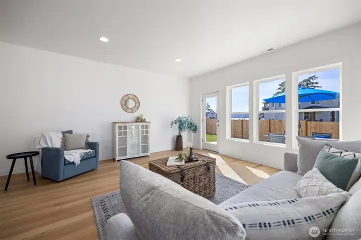 The living room looks out to the saltwater views and opens to the patio.
