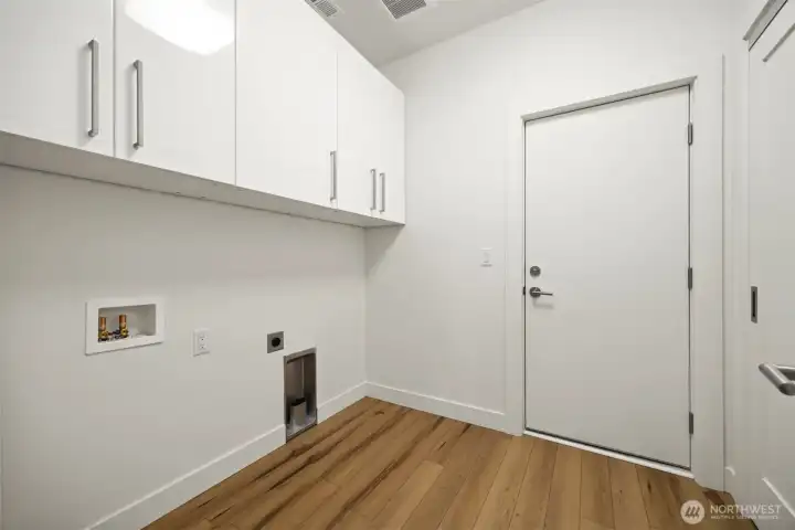 The laundry room is conveniently located adjacent to the garage, and has a large storage/coat closet.