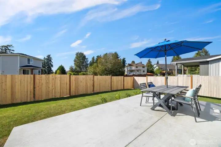 Looking at the rear patio and fully fenced rear yard.