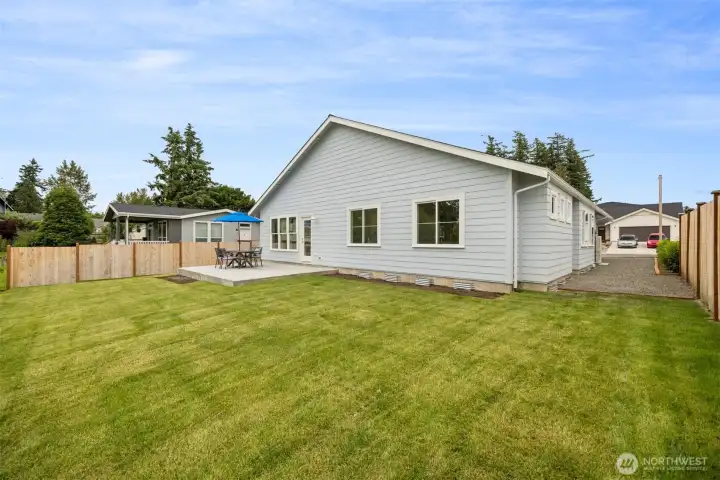 Looking across the rear yard toward the back patio which is off of the living room.