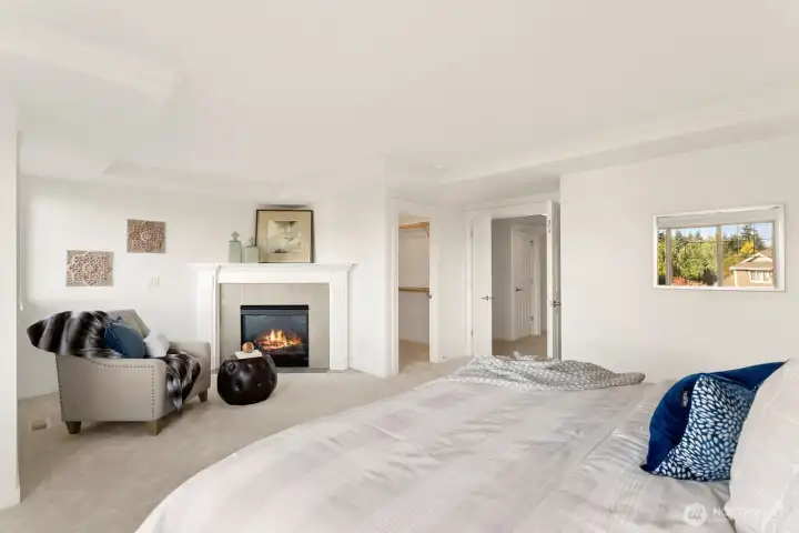 Cozy sitting area and gas fireplace in primary suite