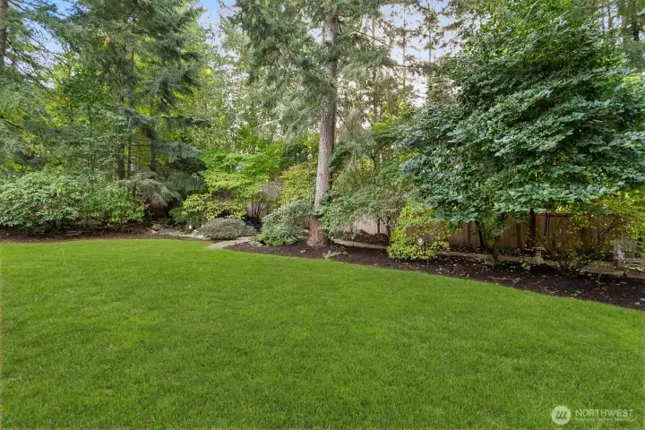 Explore on your own property with a sweet bridge over a flowing waterfall feature (not currently in use) into a little pond.