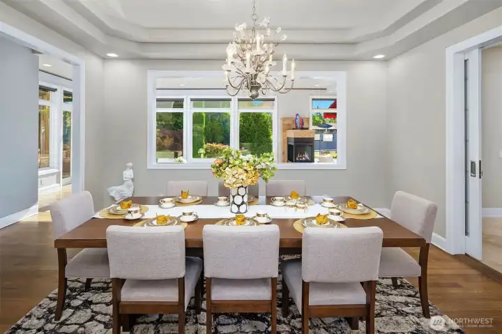 Bright Dining room has a coved ceiling & glass pocket door