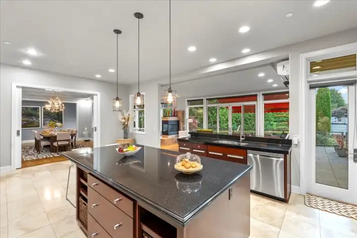 The Kitchen is the heart of the home and open to the formal dining room, informal dining room, living room, and a door straight out to the deck