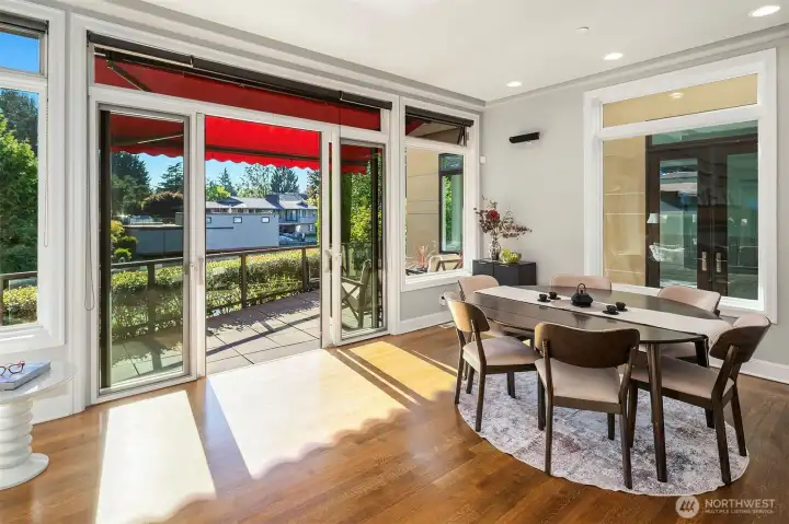 Informal dining room opens to deck overlooking the canal. It could also be used as a second living room