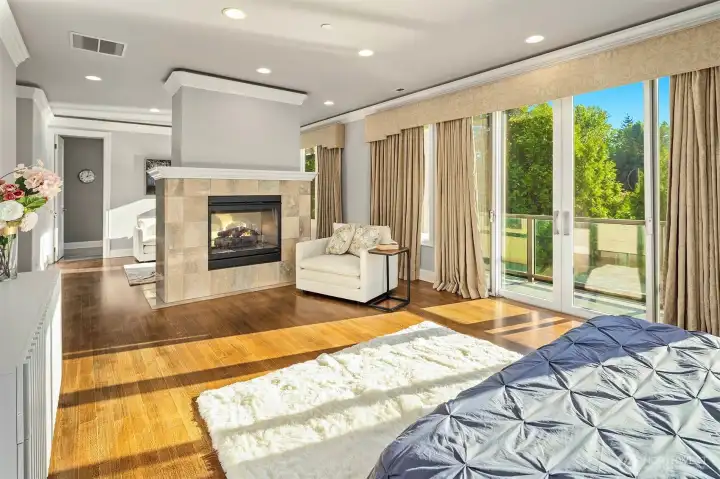 Large primary retreat with double fireplace with privte deck access