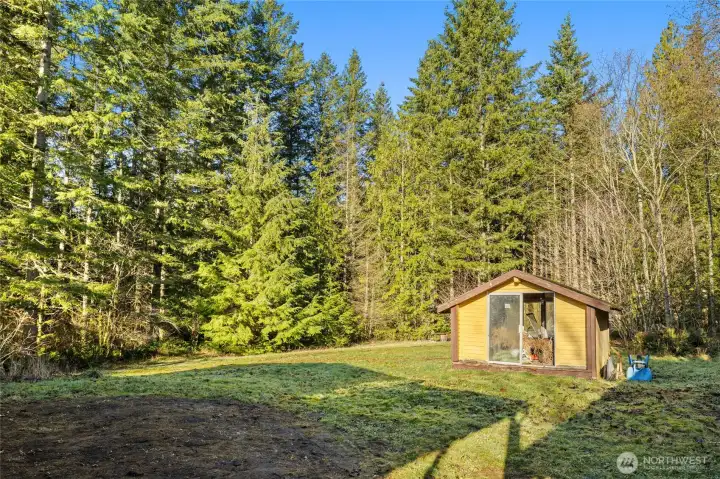 Outbuilding needs work but would make great greenhouse, play area or use your imagination.