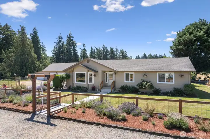 Home plus large detached garage with shop and attic, surrounded by beautiful English garden landscaping.