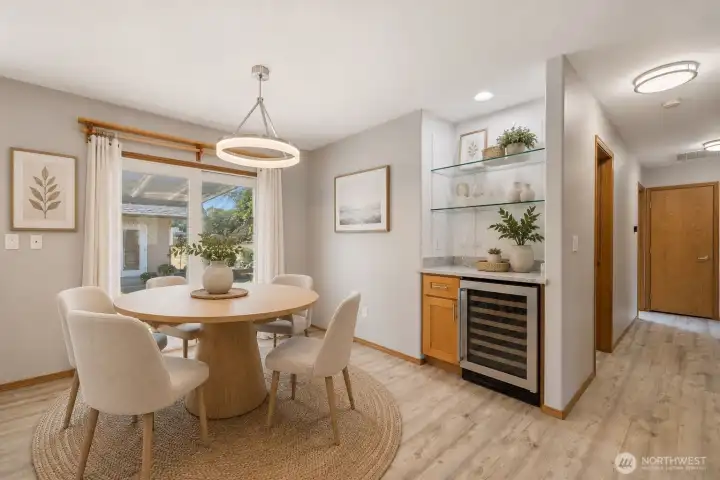 Virtually Staged: The kitchen was remodeled in 2023 with quartz countertops, upgraded hardwood cabinetry, and a built-in 48-bottle wine fridge. Durable LVP flooring runs throughout the home, paired with LED lighting for a bright, modern feel. The hot water tank was replaced in 2023, and the home features an electronic air filter with a REME HALO ionizer for improved air quality. Generator-ready circuitry and a 200-amp electrical panel add peace of mind.