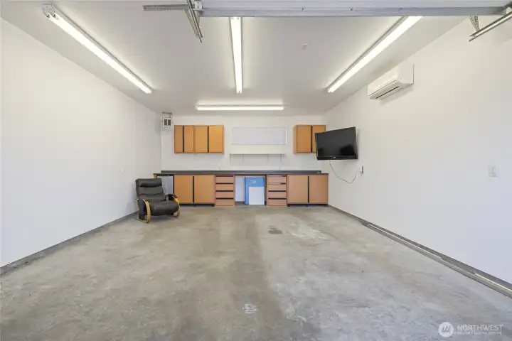 The garage and shop are fully insulated and equipped with a ductless heat pump for year-round usability. The space is piped for an air compressor, which stays with the property, and includes a 50-amp outlet for electric vehicle charging. Built-in cabinetry and a mini fridge are included, along with a dedicated gun safe cabinet (safe not included). A 220-volt welding plug and a 200-amp service panel support a wide range of uses.