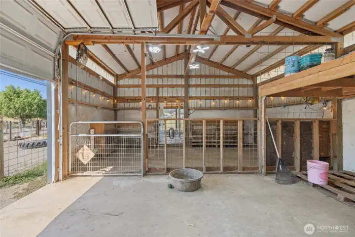 Barn- A car-charger plug is in place for added convenience. The space also features built-in livestock feeders, dedicated hay storage, and a defined pen area with durable concrete flooring. Cross-fencing and effective field drainage complete the setup.