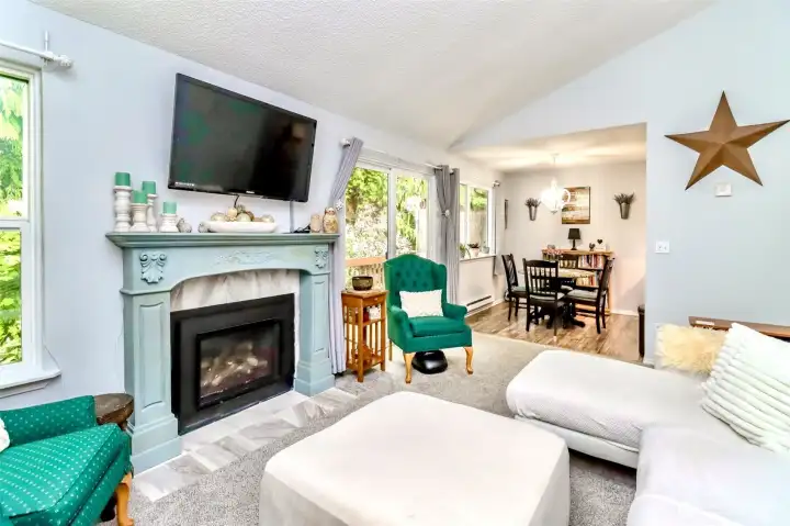 Living room with cozy gas fireplace that heats the entire condo and saves on the utility bill