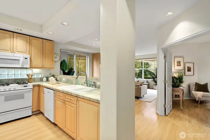 Here from the main hallway, catching the Kitchen, living room and part of the primary bedroom. All conveniently located.