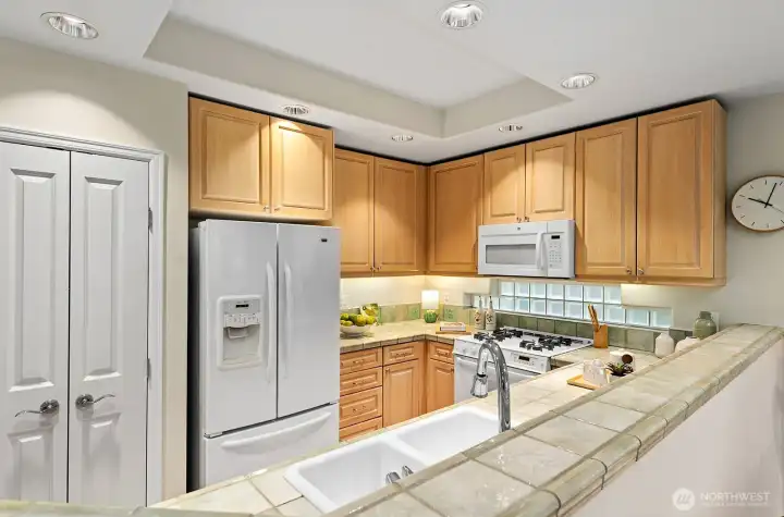 Here catching all of the kitchen including the double door pantry. Plenty of ceiling and  under cabinet lighting.