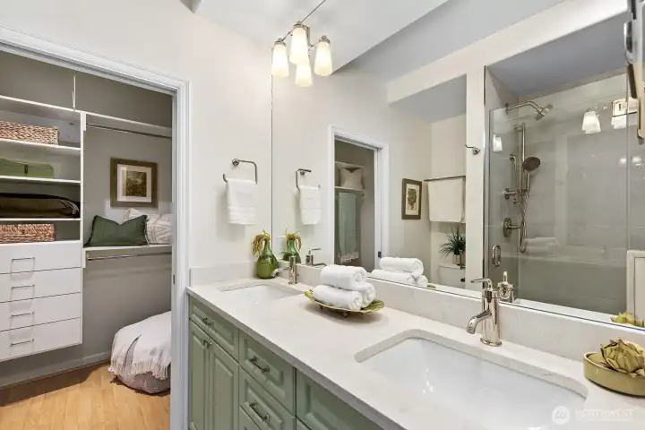 This update primary bathroom, double sink vanity with quartz countertop is beautiful. Looking into the walk-in closet.