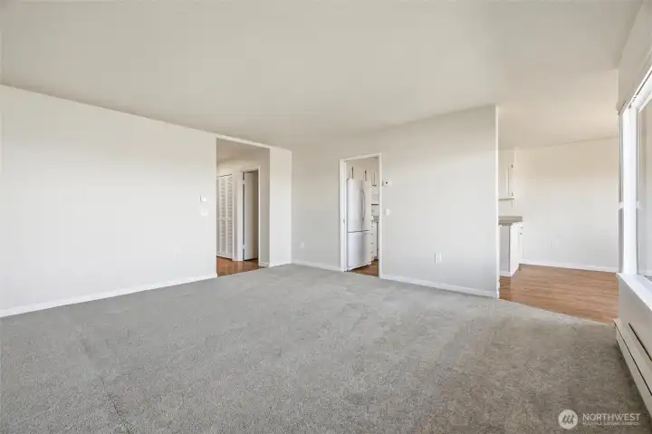 View of entryways to hallways, kitchen and dining area
