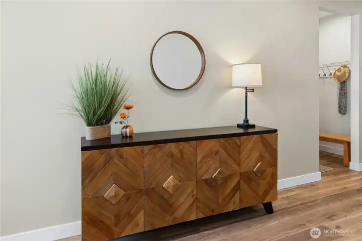 Large open entryway with with designer wide-plank flooring throughout