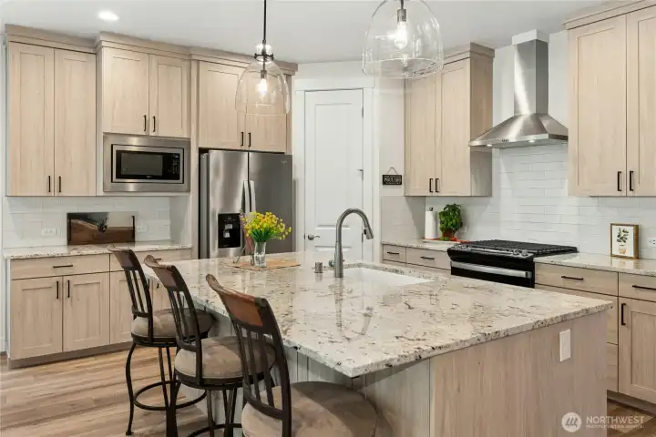 Chefs kitchen with upgraded Oasis Roble Atlas cabinetry