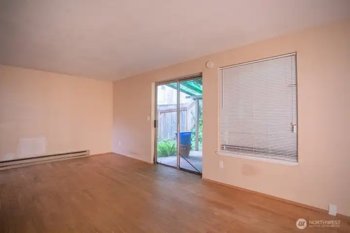 living room, looking from dining room with door to back yard