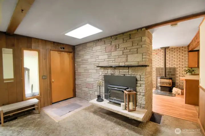 Enter to the living room, featuring the retro fireplace you'll love for the look and appreciate on cozy wintry days.